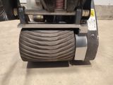 a close up of a forklift with a tire on it