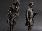 a pair of bronze figures of a man and a woman