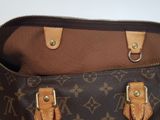 a brown and black bag with two handles on it