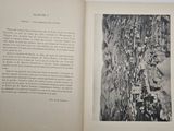 an open book with a black and white photo of a forest