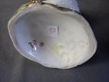 a close up of a white porcelain object on a table