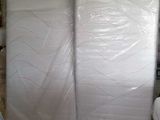a room with a lot of white mattresses in it