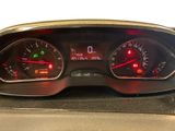 the dashboard of a car with red and green gauges on it