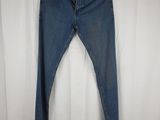 the back of a pair of blue jeans hanging on a white curtain