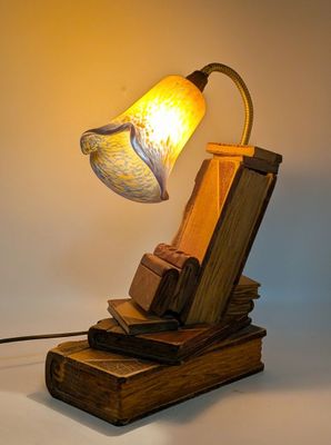 a lamp that is sitting on top of a pile of books