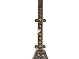an ornate cross on a stand on a white background