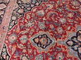 a large red rug on the floor in a living room