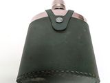 a green leather flask with a metal top