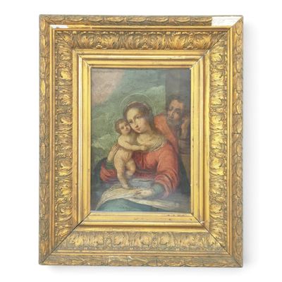 un tableau représentant une femme tenant un bébé dans ses bras, dans un cadre doré