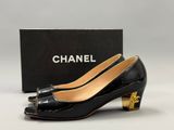 chanel black patent pumps with gold heel
