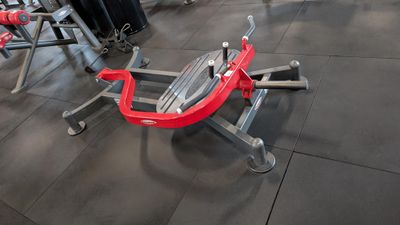 a gym area with a row of exercise equipment on the floor
