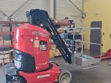 a red scissor sitting in a warehouse with boxes on the floor