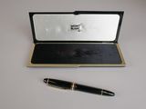 a pen sitting on top of a box with a pen in it