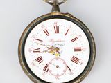 a pocket watch with roman numerals on the face