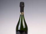 a bottle of champagne sitting on top of a white table