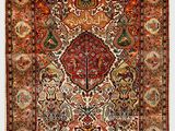 an antique persian rug with a floral design on a white background