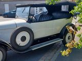 a vintage car parked on the side of the road