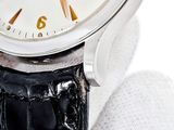 a close up of a wrist watch with a black leather strap