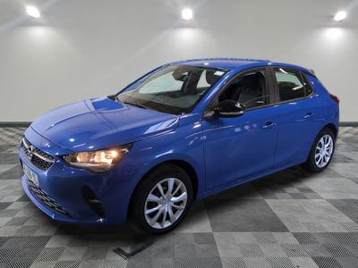 a blue car parked in a garage with a checkered floor