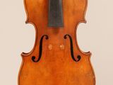 an old violin with a bow hanging from it ' s back