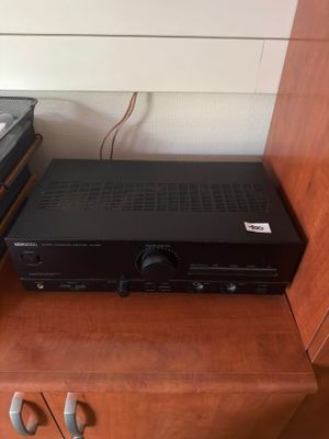 a black receiver sitting on top of a wooden cabinet