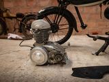 a small engine sitting on the ground next to a bike