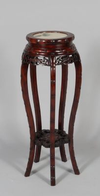 a small wooden table with a marble top on it