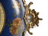 a blue vase with a gold trim and a clock on it