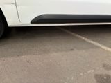 a white car that is parked in a parking lot
