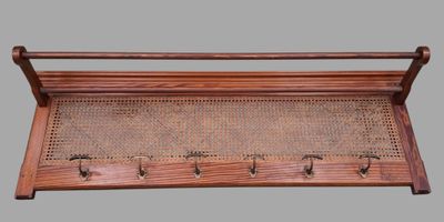 an old wooden rack with four pegs and four pegs on it