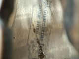 a close up of a metal object with writing on it