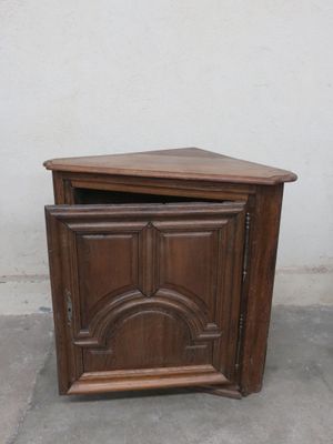 a small wooden cabinet with a door on top of it
