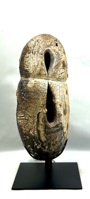 une sculpture représentant un oiseau dont le visage est percé d'un trou