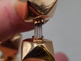 a person that is holding a gold object in their hand