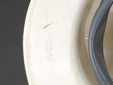 a close up of a white hat with a black cord