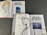 three books that are open on a table