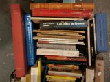 many books stacked on top of each other on a shelf