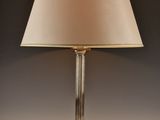a lamp that is sitting on a table with a lamp shade