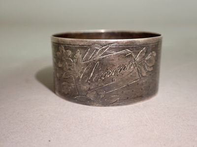 a silver ring with a design on it on a table