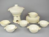 a lot of white dishes and cups on the table