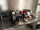a lot of appliances on the counter in the kitchen