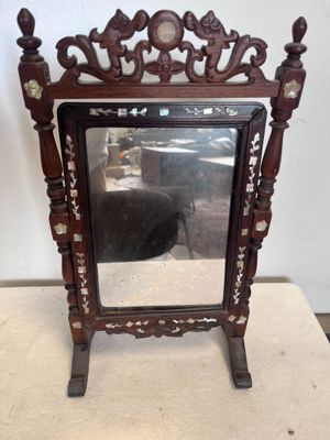 une image représentant un miroir posé sur un socle en bois