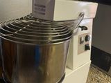 a mixer that is sitting on the ground next to a counter