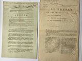 two old papers with writing on them sitting on a table
