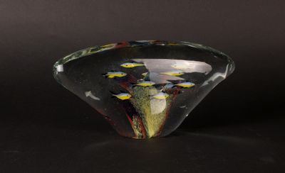 a small glass bowl with yellow flowers inside of it