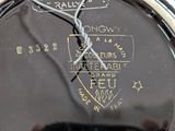 a close up of a clock with a wire on it