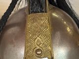 a helmet that has a gold decoration on it