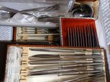 a lot of silverware in a box on a table