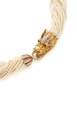 a close up of a necklace with pearls and a dragon head