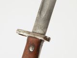 a close up of a knife with a wooden handle